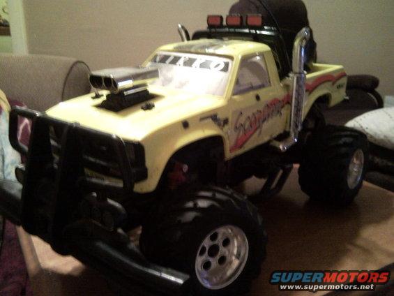 Yellow RC monster truck with scoop and 'Scorpion' graphics
