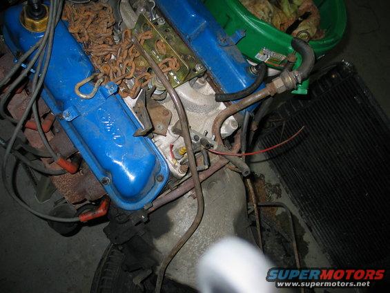 Ford V8 engine with blue valve covers and rusty chain on top