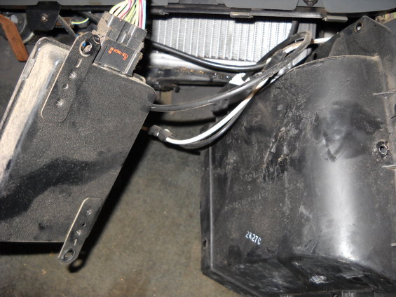 Heater core and blower motor housing with wiring harness and hoses connected