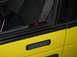2002 Ford Taurus - A yellow car door is visible with a keypad entry system and a red indicator light above the window.
