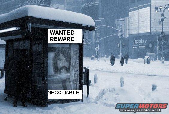 Wanted poster of a man with long hair in a snowy bus stop with "WANTED REWARD NEGOTIABLE" text