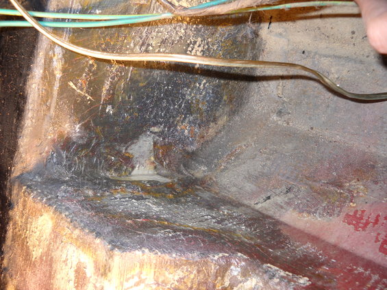 Interior floor pan with wiring and rust damage