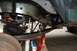 1994 Ford Bronco - Close-up of a vehicle's undercarriage, showing leaf springs and suspension components supported by red jack stands.