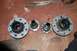 1994 Ford Bronco - Several vehicle hub assemblies and metal rods are laid out on a surface.