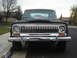 1977 Jeep Cherokee - Front view of a 1977 Jeep Cherokee, identifiable by its grille, with a 'For Sale' sign in the window.