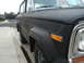 1977 Jeep Cherokee - A black 1977 Jeep Cherokee is parked curbside, displaying a 'FOR SALE' sign in the windshield.