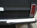 1977 Jeep Cherokee - Rear view of a black 1977 Jeep Cherokee showing its tailgate, chrome bumper, and taillight.