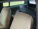 1977 Jeep Cherokee - Interior view of a vehicle, showing tan and black seats and windows. Watermark present.