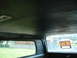 1977 Jeep Cherokee - The interior of a vehicle is shown, with a 'FOR SALE' sign visible in the rear window.