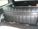 1977 Jeep Cherokee - The interior of a vehicle shows a black vinyl rear seat with seatbelts.