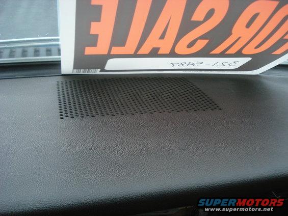 Dashboard speaker grille with a 'FOR SALE' sign partially obscuring it