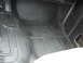 1977 Jeep Cherokee - The interior floor of a vehicle shows a worn black mat with some debris and a partial view of a white seat.
