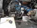 1977 Jeep Cherokee - Close-up view of a vehicle's engine bay, showing various components and wiring. The Supermotors.net logo is present in the lower right corn…