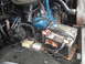 1977 Jeep Cherokee - Close-up view of a vehicle's engine bay, focusing on the battery and engine components.