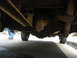 1977 Jeep Cherokee - This photo shows the undercarriage of a vehicle, focusing on the rear differential and suspension components.
