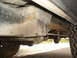 1977 Jeep Cherokee - A close-up view of a vehicle's undercarriage reveals signs of wear and rust on its suspension components.