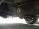 1977 Jeep Cherokee - Underside view of a vehicle's frame and suspension components, including leaf springs and a tire. The registry claims it is a 1977 Jeep Che…