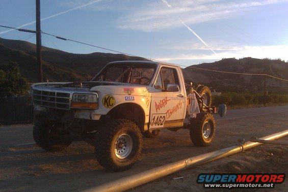 1995 Ford F-150 race truck with number 1462 and 'Angry Issues' text, spare tire mounted on rear