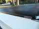 1973 Ford Ranchero - A white vehicle's bed is covered by a black Protect-O-Top cover.