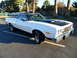 1973 Ford Ranchero - This 1973 Ford Ranchero features a two-tone paint scheme with a black hood scoop and vinyl top.