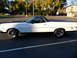 1973 Ford Ranchero - A white 1973 Ford Ranchero is parked in a lot, showing its side profile and black accents.