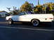 1973 Ford Ranchero - A white 1973 Ford Ranchero with a black vinyl top is parked on asphalt under a clear sky.