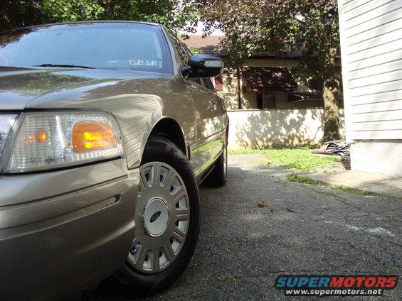 Tan 2004 Ford Crown Victoria, front passenger side, parked on asphalt driveway