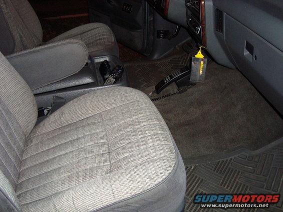 Interior of a 1991 Ford Bronco showing front seats, center console with phone, and dashboard
