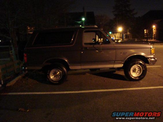 Side view of a 1991 Ford Bronco parked at night