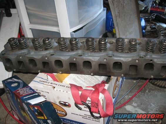 Engine cylinder head with springs, sitting on boxes