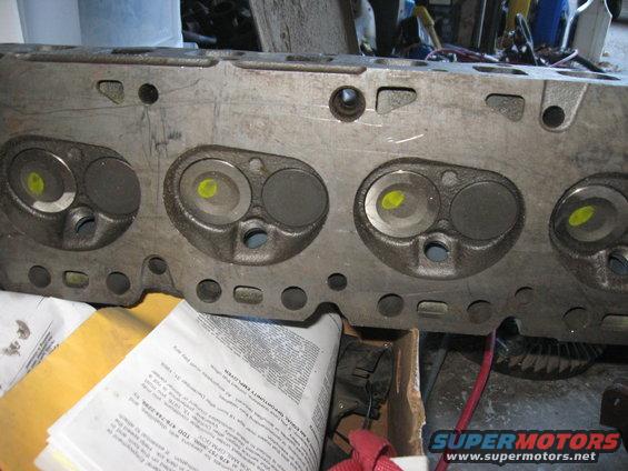 Engine cylinder head with four sets of valves, yellow markings on intake valves