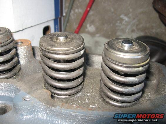 Close-up of valve springs and retainers on an engine cylinder head