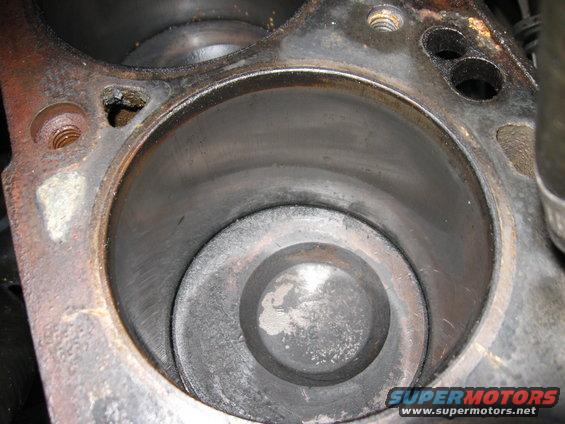 Close-up of an engine cylinder with piston visible inside