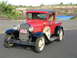 1931 Ford Model A - This red pickup truck has a sign on the grille that reads 'HERS 2 DRIVE MINE 2 FIX'.
