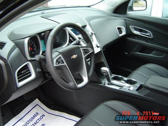 2011 Chevrolet Equinox interior with leather seats, dashboard, steering wheel, and center console