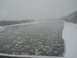 2009 Kenworth T800 - Winter scene of a river partially covered in ice floes under a cloudy sky.