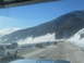 2009 Kenworth T800 - Driving through a snowy mountain pass with multiple vehicles on the road.