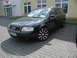 2003 Audi A6 - A black Audi wagon is parked outside a building with a red triangular sign above the entrance.