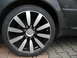 2003 Audi A6 - Close-up of a car's wheel and tire, a multi-spoke design and visible tire sidewall text. The 'SUPERMOTORS' watermark is present.