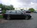 2003 Audi A6 - Side view of a dark Audi A6 Avant parked on paver stones with other vehicles nearby.