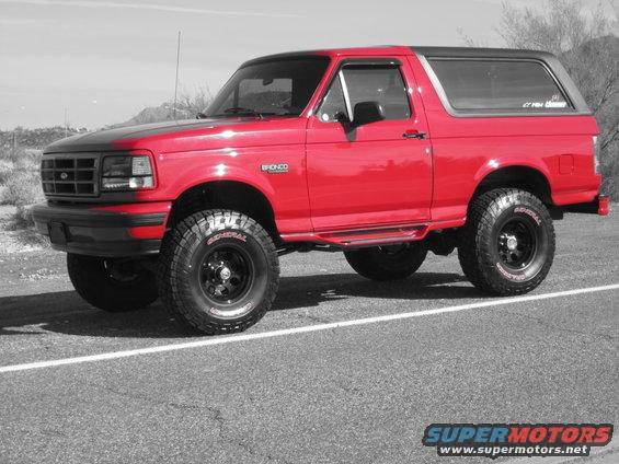 Red 1996 Ford Bronco, 3/4 front view, with black hood and roof