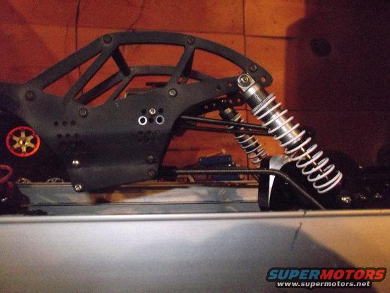 RC car chassis with roll cage and shocks