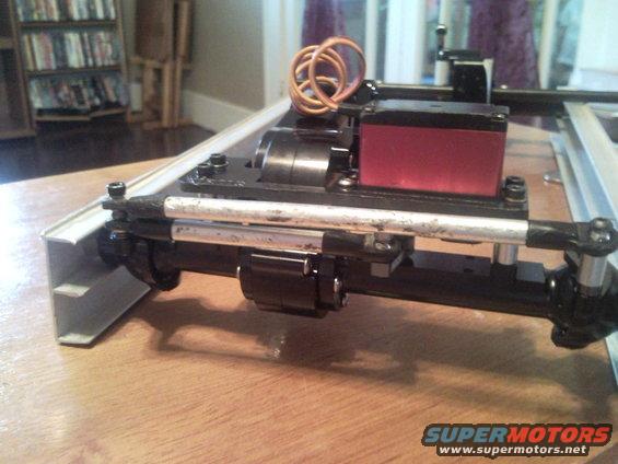 RC car chassis with red servo motor and copper wiring