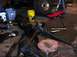 1992 Ford Bronco - Various vehicle axle and suspension components are disassembled and scattered on the ground in a workshop setting that appears to be a gara…
