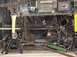 1992 Ford Bronco - The underside of a vehicle is shown, with a winch mounted and suspension parts supported by jack stands.