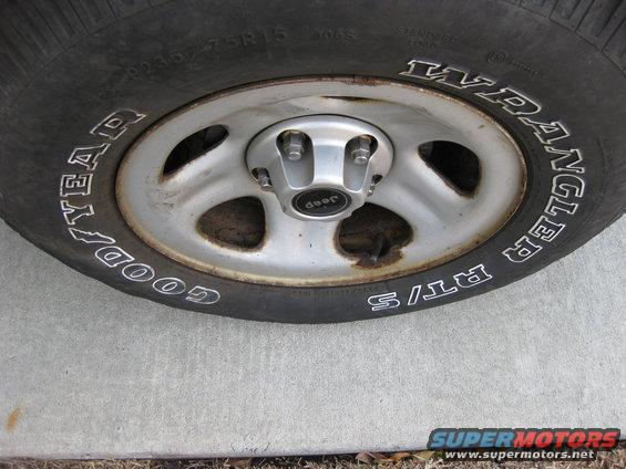Close-up of a Jeep Wrangler tire with 'Goodyear Wrangler RT/S' text and a Jeep center cap