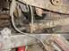1992 Ford Bronco - Underside view of a vehicle's drivetrain components, including the driveshaft and differential.