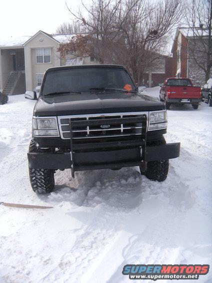 Black Ford Bronco with a brush guard in the snow, front view
