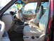 1999 Ford Expedition - The interior of a red Ford Expedition is shown, tan leather seats and a dashboard.