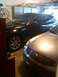 2007 Infiniti FX35 - A black 2007 Infiniti FX35 is parked in a garage, partially obscured by another vehicle.